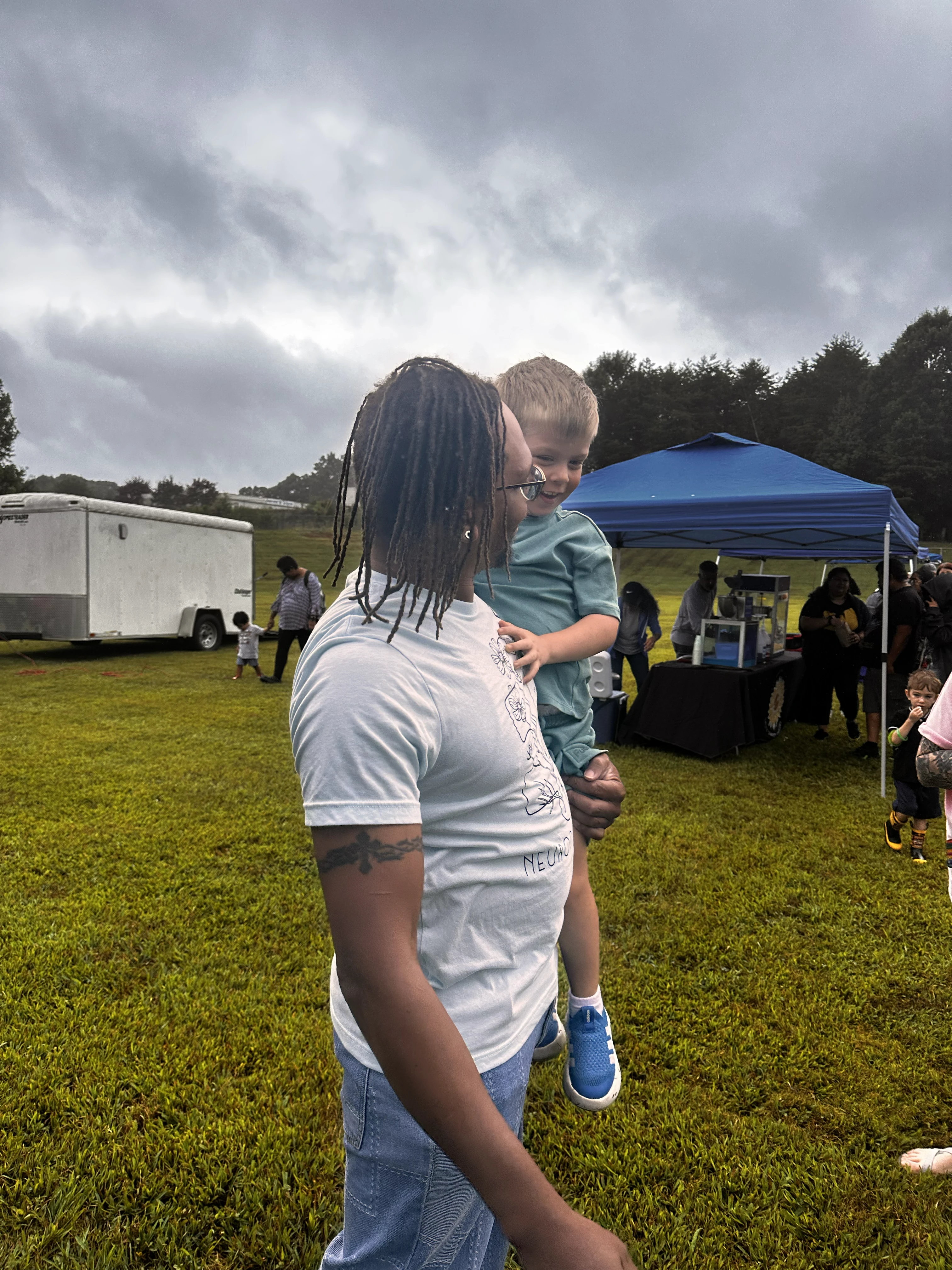 Therapist holding child outdoors